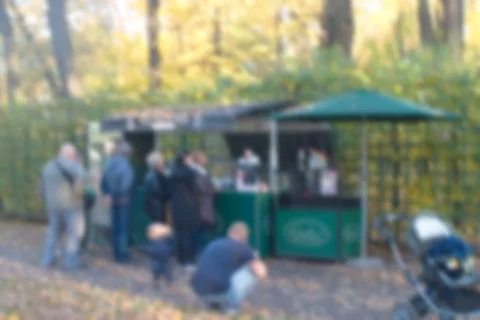 A blurry image of a queue of shoppers at a shopping tent in the Park in the f Stock Photos