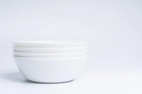 Blurry image of three small white bowls isolated on white background include  Stock Photos