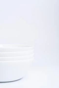 Blurry image of three small white bowls isolated on white background include  Stock Photos