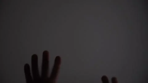 A blurry image of two hands with a dark background Stock Footage 304286500