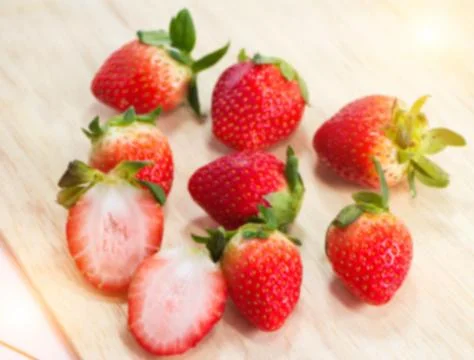 The blurry light design background of red strawberry put on timber board,blur Stock Photos