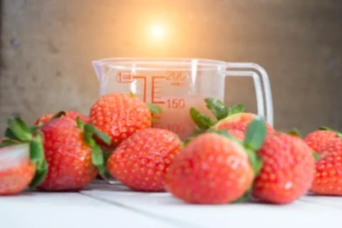 The blurry light design background of red strawberry and strawberry juice gla Stock Photos