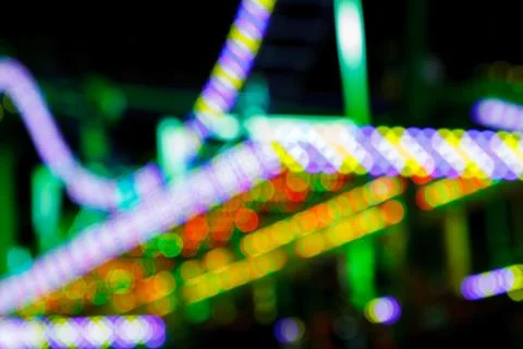 Blurry lights of an amusement night park. Stock Photos