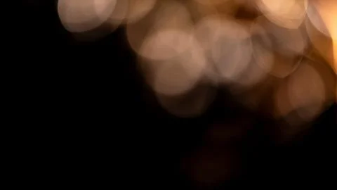 Blurry lights create soft, out of focus golden circles, adding warm glow an.. Foto stock