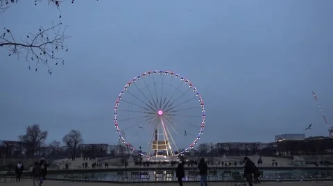 Blurry lights of a ferris wheel reflecting from the ice in Champs Elysee Stock Footage 59797403