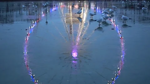 Blurry lights of a ferris wheel reflecting from the ice. Stock Footage 59797794