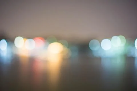 Blurry lights at night on the river. Stock Photos