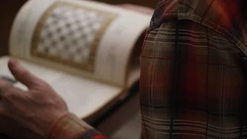 Blurry man is studying chess textbook. visual aid. view over his shoulder. hobby Stock Footage 305851966