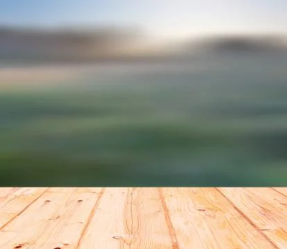 Blurry meadow landscape with wooden floor on foreground Stock Illustration