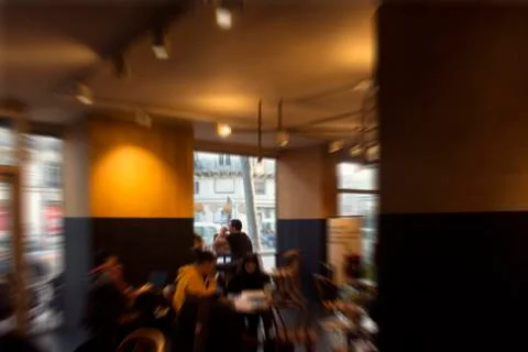 Blurry motion image of people inside a cafe / coffee shop. Stock Photos