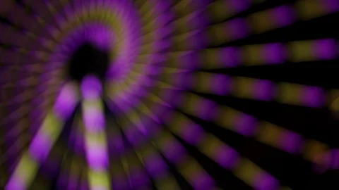 Blurry night shot of spiraling light on ferris wheel Stock Footage 122512302