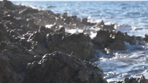 Blurry ocean waves crash softly against a rocky coastal shore. Stock Footage 337407395