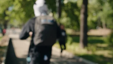 Blurry people running in a park during a city marathon Stock Footage 343044562