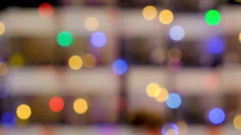 Blurry rare multi-colored lights flash against a fawn fuzzy background. Festive Stock-Footage 165240307