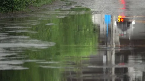 A blurry reflection of a car and a truck in a puddle of water Stock Footage 289316568