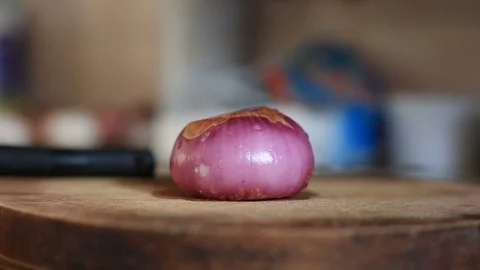 Blurry shallow focus view of cutting onion with knife by asian Video stock 129529767