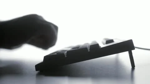 Blurry silhouette of man typing Stock Footage 12990529