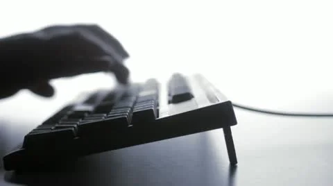 Blurry silhouette of man typing, tracking Stockbeeldmateriaal 12989078