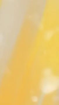 Blurry, soft-focus gradient of muted yellow and beige tones. Stock Photos