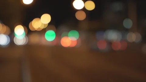 Blurry traffic lights located along night street road Stock Footage 116986181