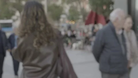 Blurry unrecognizable elderly couple walking in a city street Stock Footage 329592726