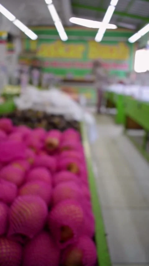 Blurry Vertical video people walking in market fruits Stock Footage 265698084