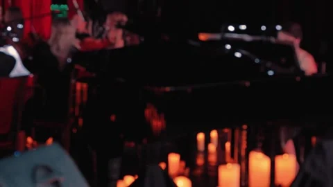 A blurry video of the orchestra performing, with candles illuminating Stock Footage 344872989