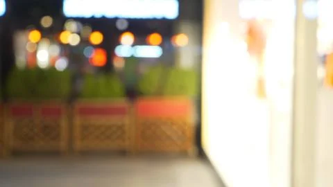 Blurry view of brightly lit storefront in Paris, France at night for composit Foto stock