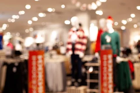 Blurry view of a bustling mall interior with various shops and boutiques, cap Stock Photos