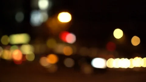 Blurry view of busy intersection at night with traffic passing by Stock Footage 123901180