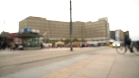 Blurry view of busy public square with tram arriving at station Video stock 123901253