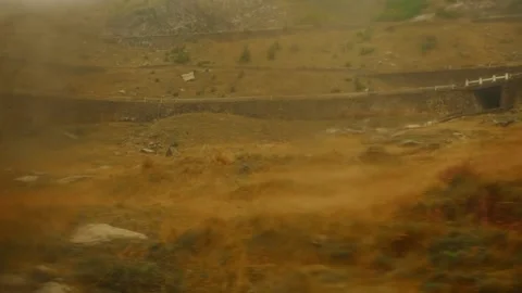Blurry view from car window, rainy landscape, mountains in Romania. Stock Footage 212012411