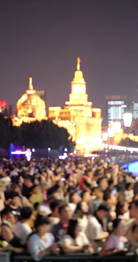Blurry view of crowd watching a night show in Shanghai at The Bund Stock Footage 327649801