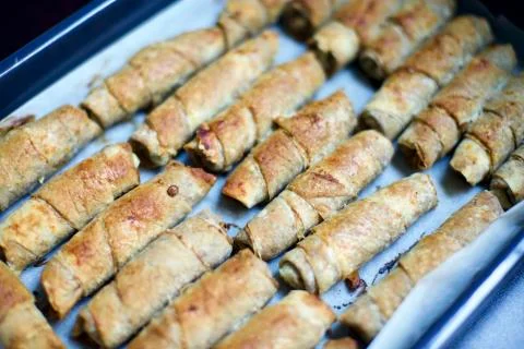 Blurry view of home made spring rolls. It contains lentils, poppy, minced meat, Stock Photos