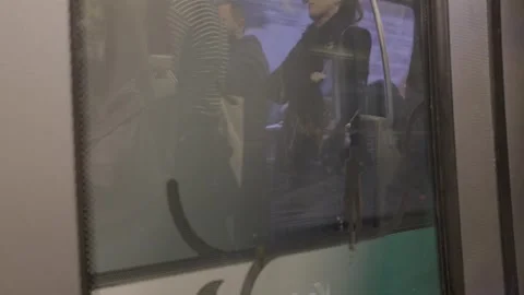 Blurry view of a subway train window with walking commuters outside in Paris Video stock 306441898
