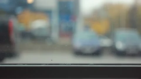 Blurry view through the window during the day in the city Видео 142930327
