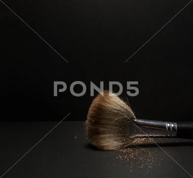 Blush brush with blush on it, loose powder and glitter blush, isolated. Stock Photos