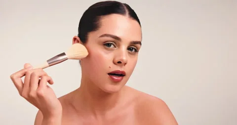 Blush, makeup brush and glow with face of woman in studio for cosmetic, beauty Stock Footage 318160246