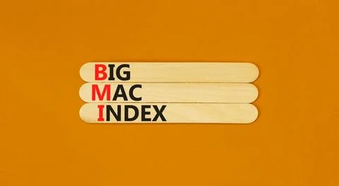 BMI big mac index symbol. Concept words BMI big mac index on wooden stick o.. Stock Photos