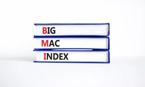 BMI big mac index symbol. Concept words BMI big mac index on books on a bea.. Stock Photos