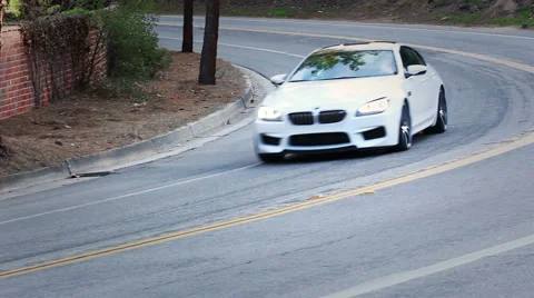 BMW Driving fast through Los Angeles hills pan Stock Footage 42886053