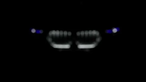 BMW X6 M presented at the Motor Show. Running bmw x6 in the dark, headlights on. Stock Footage 311647561