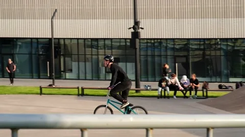BMX athlete doing tricks on a jump in slow motion on his bicycle. Stock Footage 161101392