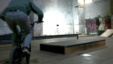 BMX Athlete Doing Tricks in underground skatebord park Stock Footage 86173948