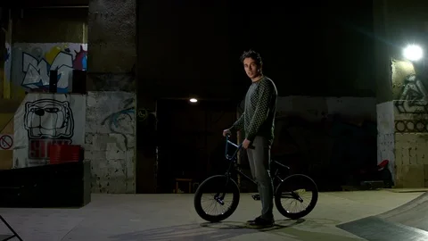 BMX Athlete Doing Tricks in underground skatebord park Stock Footage 86175332