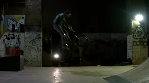 BMX Athlete Doing Tricks in underground skatebord park Stock Footage 86175340