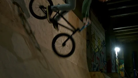 BMX Athlete Doing Tricks in underground skatebord park Stock Footage 86175358