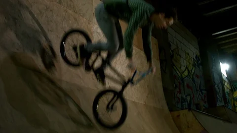 BMX Athlete Doing Tricks in underground skatebord park Stock Footage 86175381