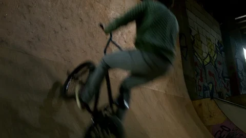 BMX Athlete Doing Tricks in underground skatebord park Stock Footage 86175390