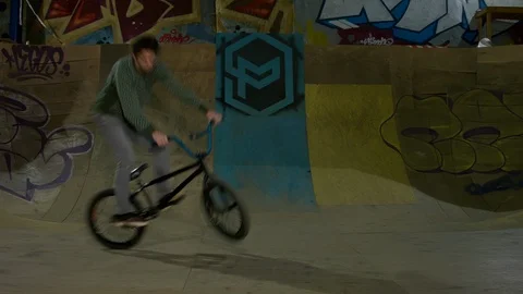 BMX Athlete Doing Tricks in underground skatebord park Stock Footage 86175990